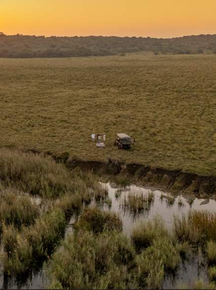 An open safari vehicle on a sand track
